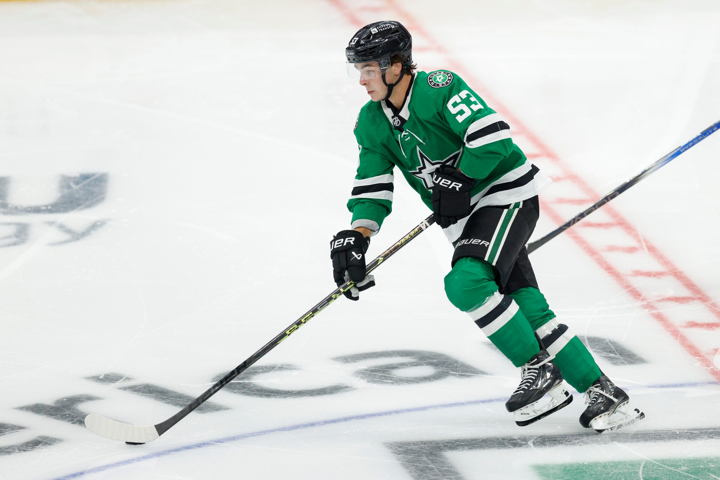 Dallas Stars center Wyatt Johnston (53) skates up the ice with the puck during the third...