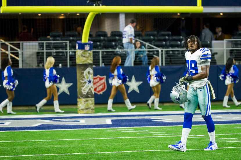 Dallas Cowboys cornerback Brandon Carr leaves the field following a 33-27 overtime loss to...