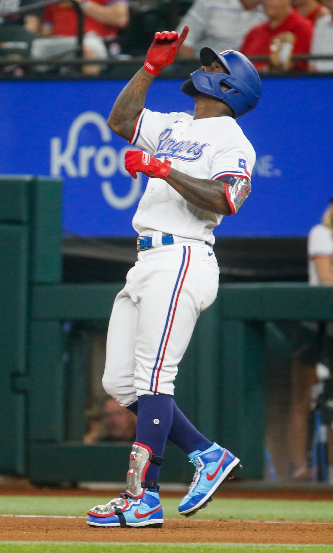 Texas Rangers right fielder Adolis Garcia (53) celebrates making it to first base after...