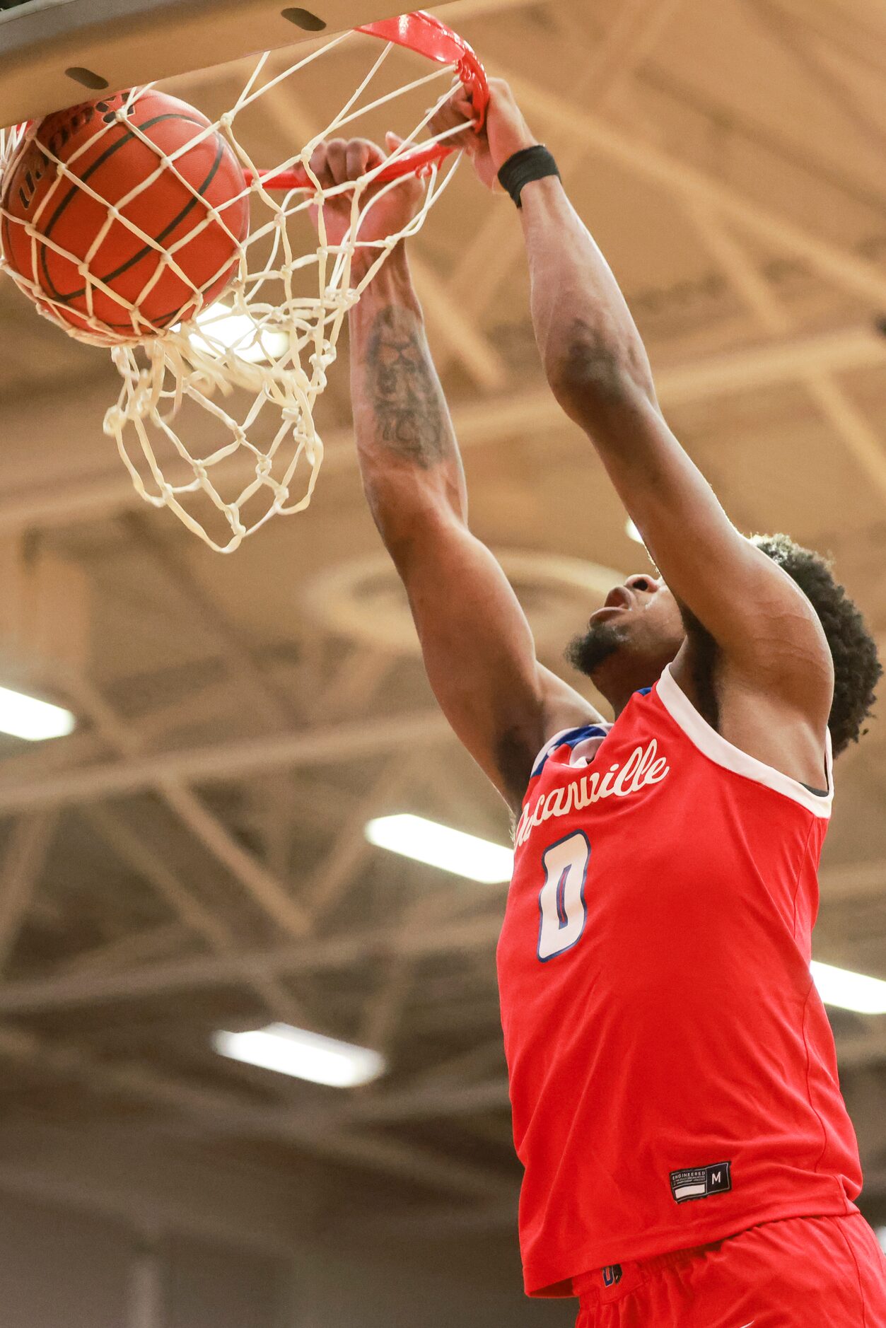 Duncanville High School’s K.J. Lewis (0) dunks during a game against Mansfield Legacy High...