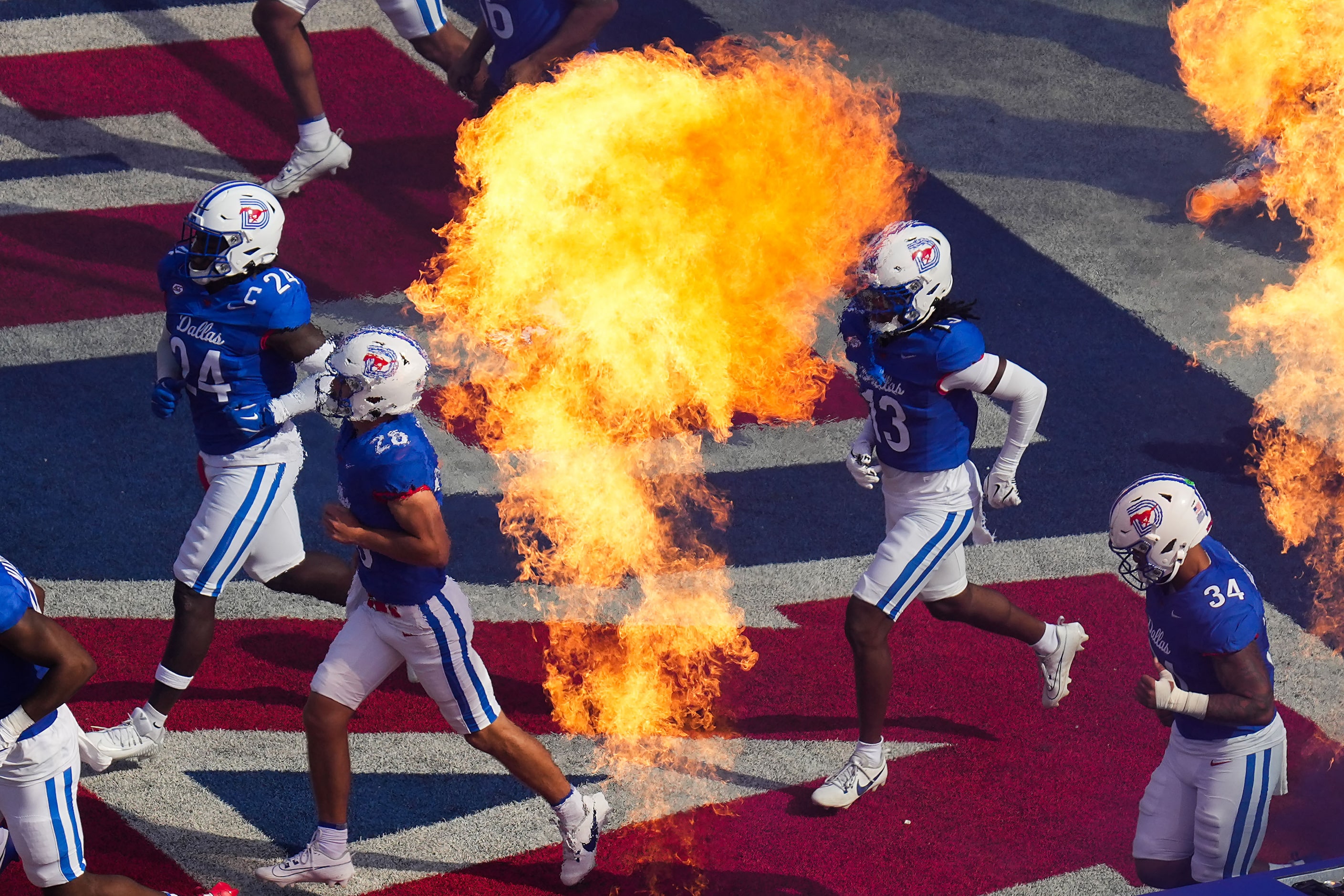 SMU players take the field before an NCAA football game against TCU at Ford Stadium on...