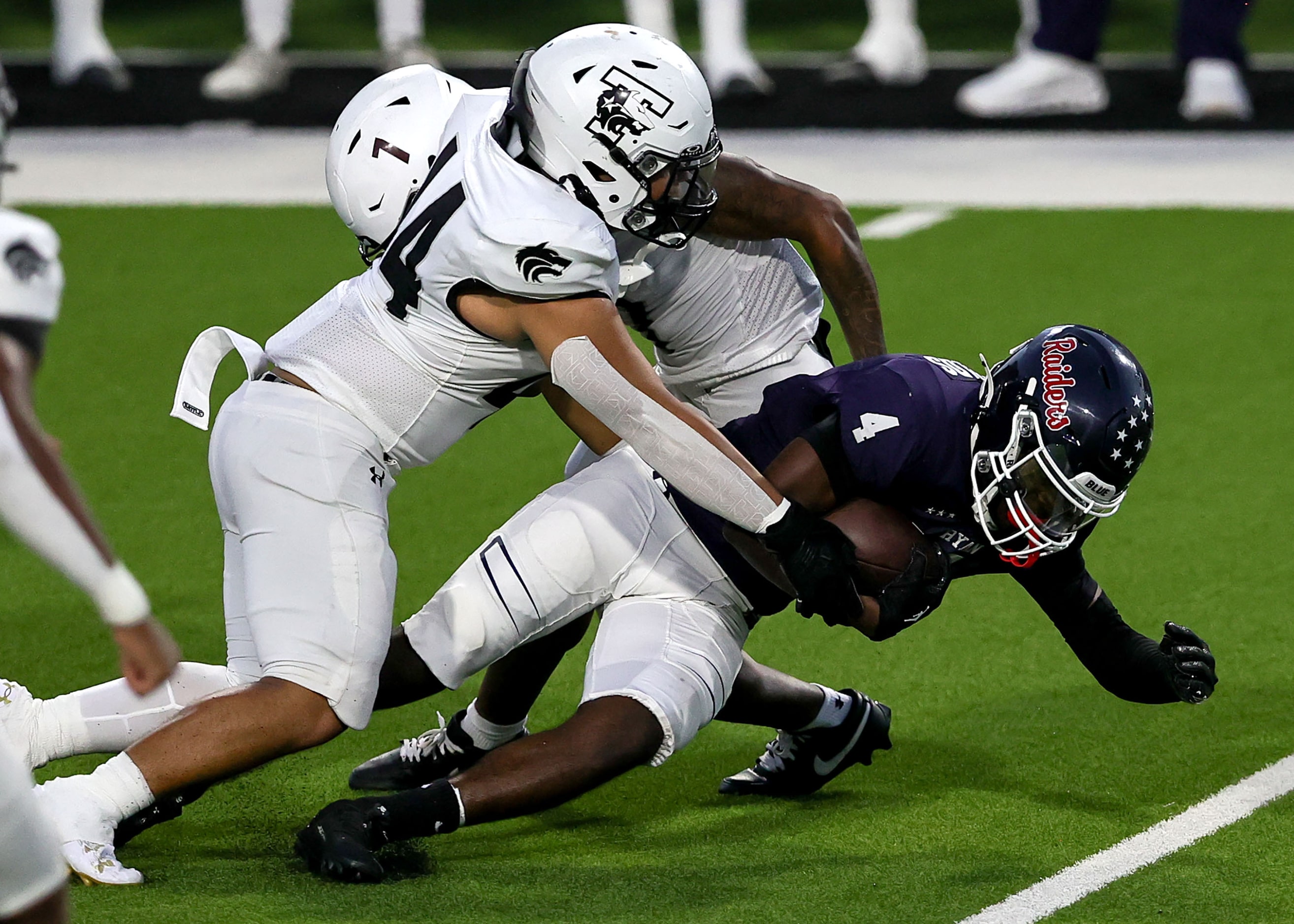 Denton Ryan running back Tre'Vaughn Reynolds (4) runs for a short gain against Mansfield...