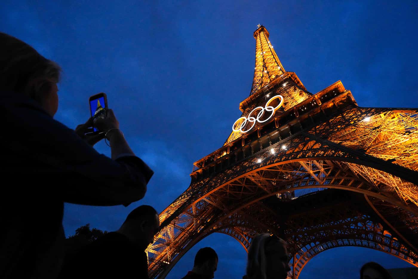 The Eiffel Tower is lighted with the Olympic rings ahead of the 2024 Summer Olympics on...