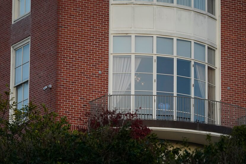 A heart shaped sculpture and a light on are seen inside a window of the home of House...