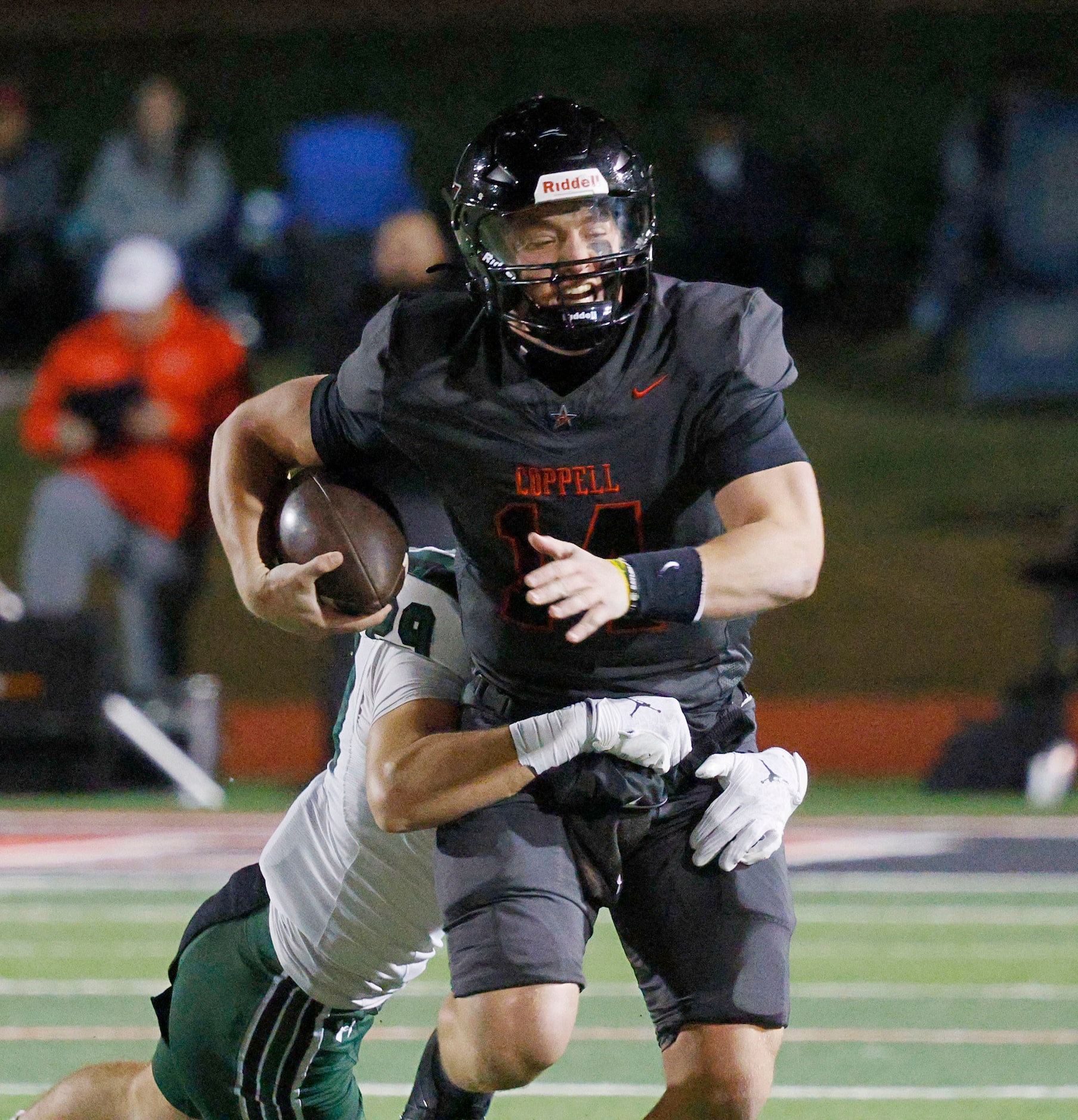 Coppell's quarterback Edward Griffin (14) is tackled by Prosper's Fahad Allan (29) in the...