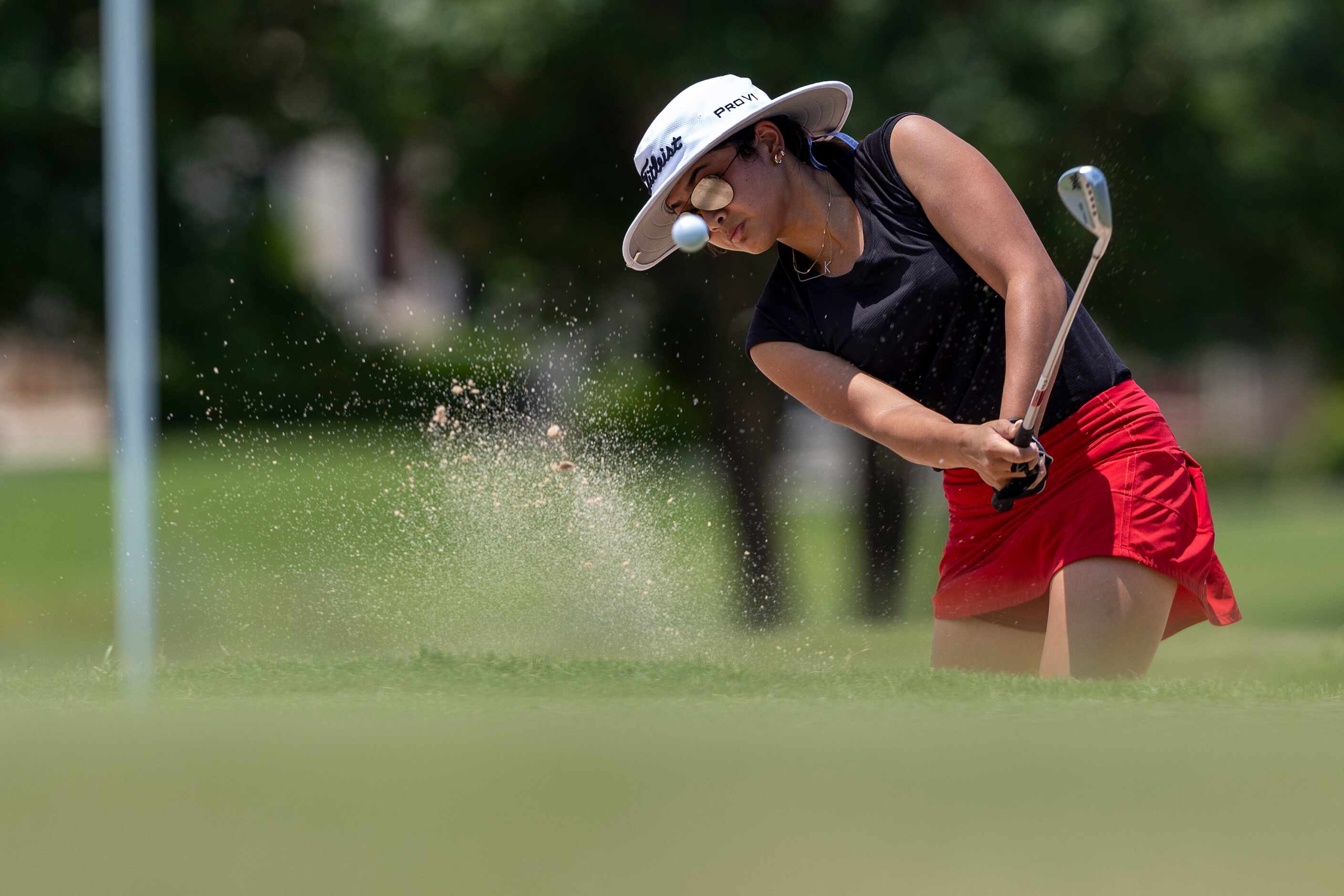 Coppell’s Kristin Angosta chips onto the 7th green during the 6A girls state golf tournament...