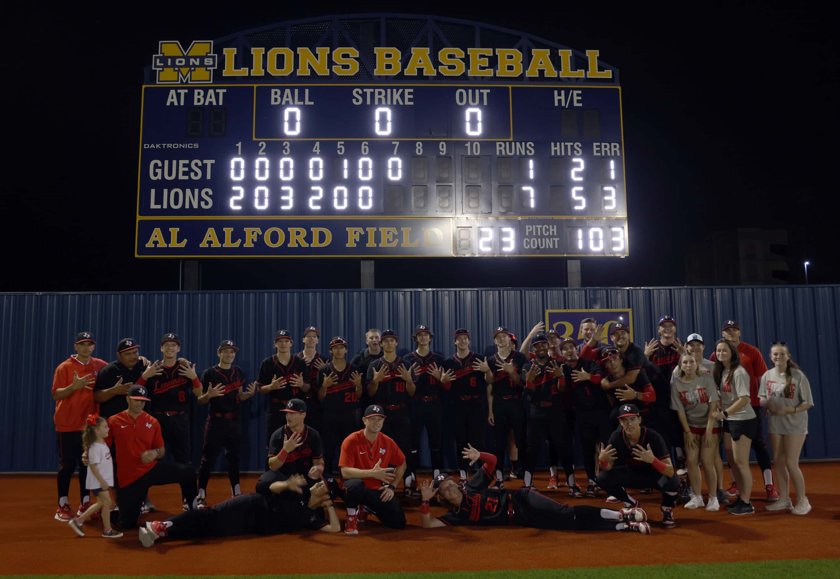 Lovejoy players, staff and coaches pose for a photo with the scoreboard  following their 7-1...