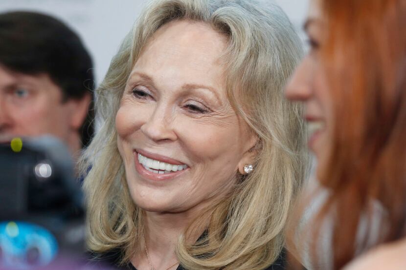 Actress Faye Dunaway  talks with various members of the media as she walks on the red carpet...