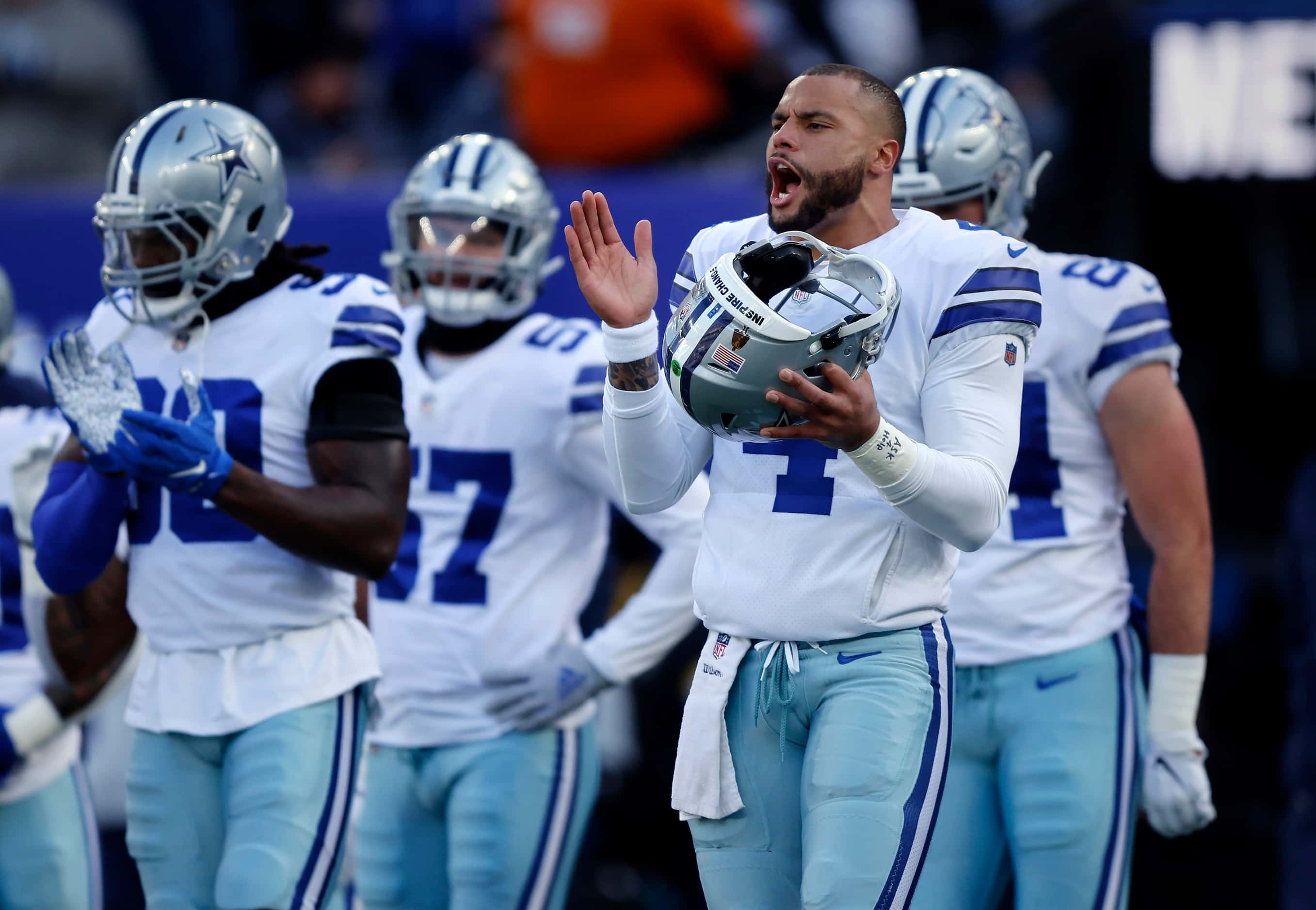 Dallas Cowboys quarterback Dak Prescott (4) gets his teammates fired up as they huddle at...