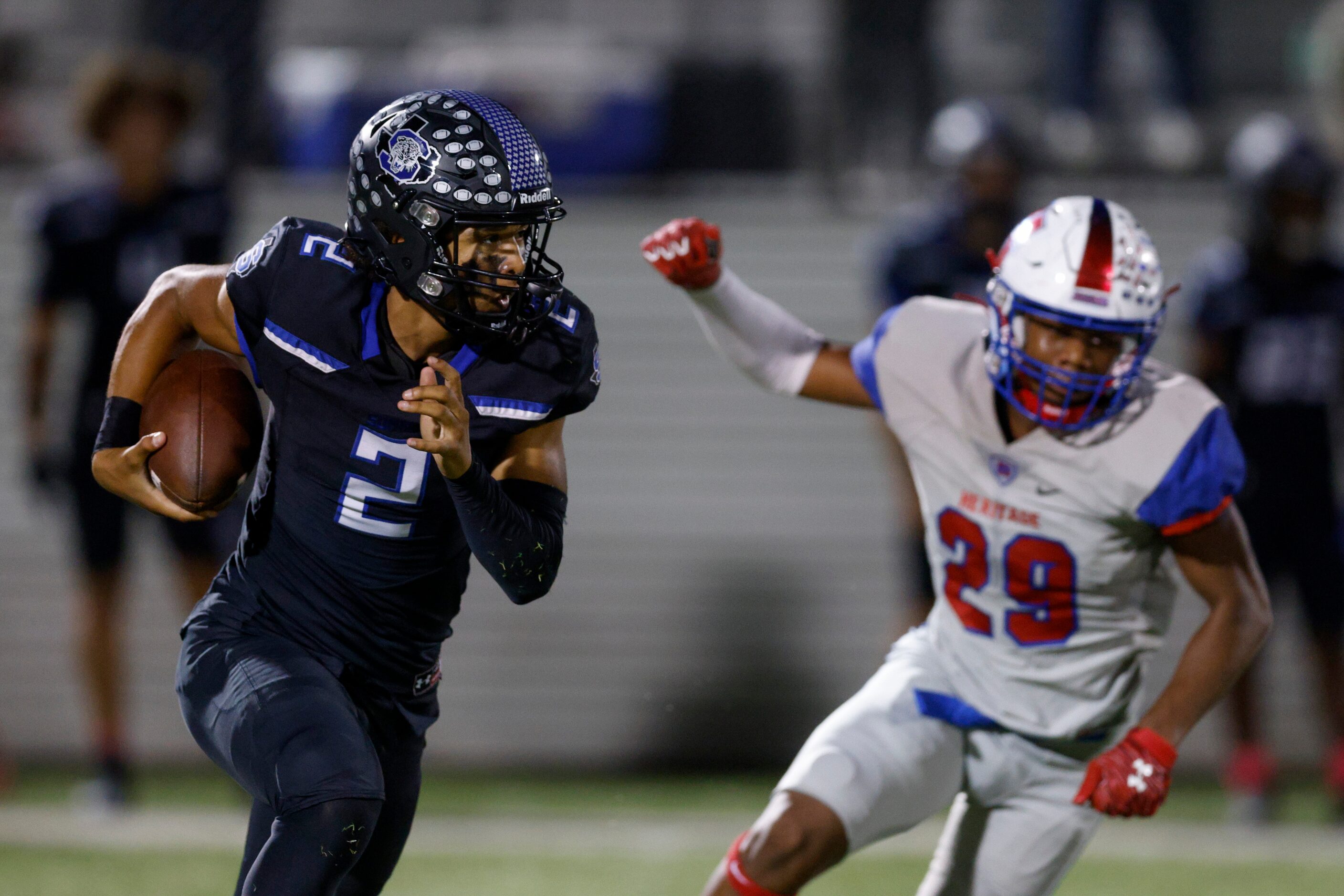 Mansfield Summit quarterback Joseph Williams (2) runs away from Midlothian Heritage...