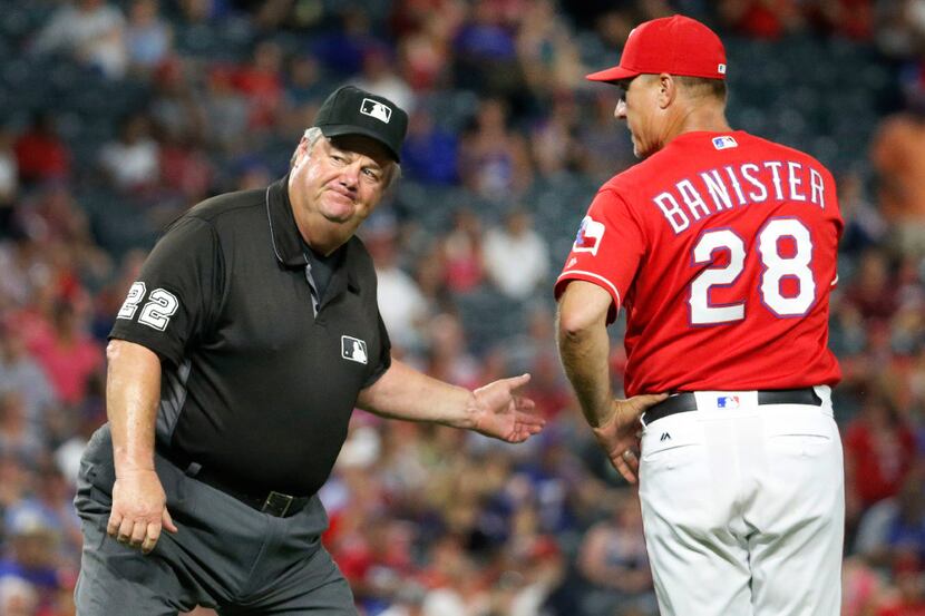 Second base umpire Joe West ejects Texas Rangers manager Jeff Banister (28) as he argues a...