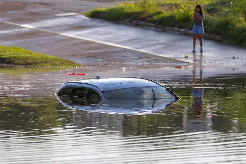 A flooded vehicle is submerged near Interstate 10 in Houston on Tuesday.