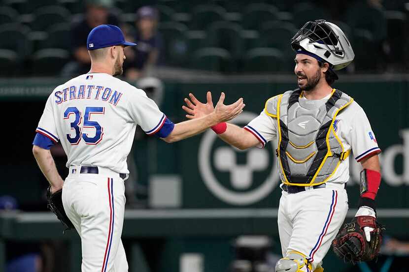 Texas Rangers relief pitcher Chris Stratton (35) and catcher Austin Hedges celebrate their...