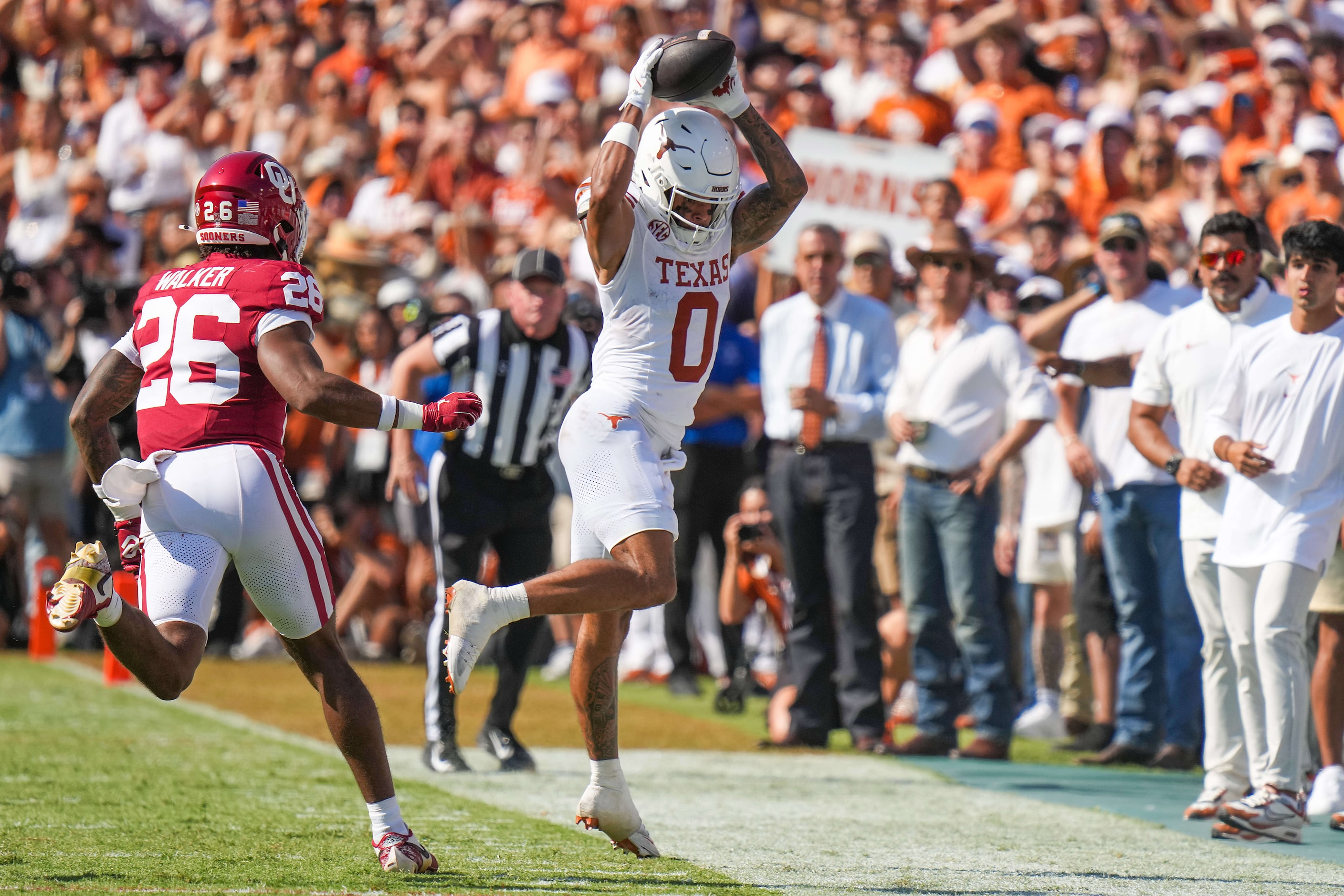 Texas wide receiver DeAndre Moore Jr. (0) comes down in bounds with a reception as Oklahoma...