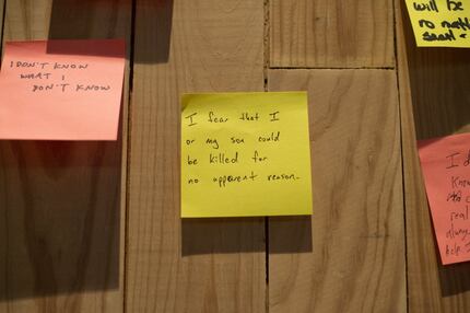 Notes hang on a designated "Wall of Truth" at a forum on race relations Friday. This one...