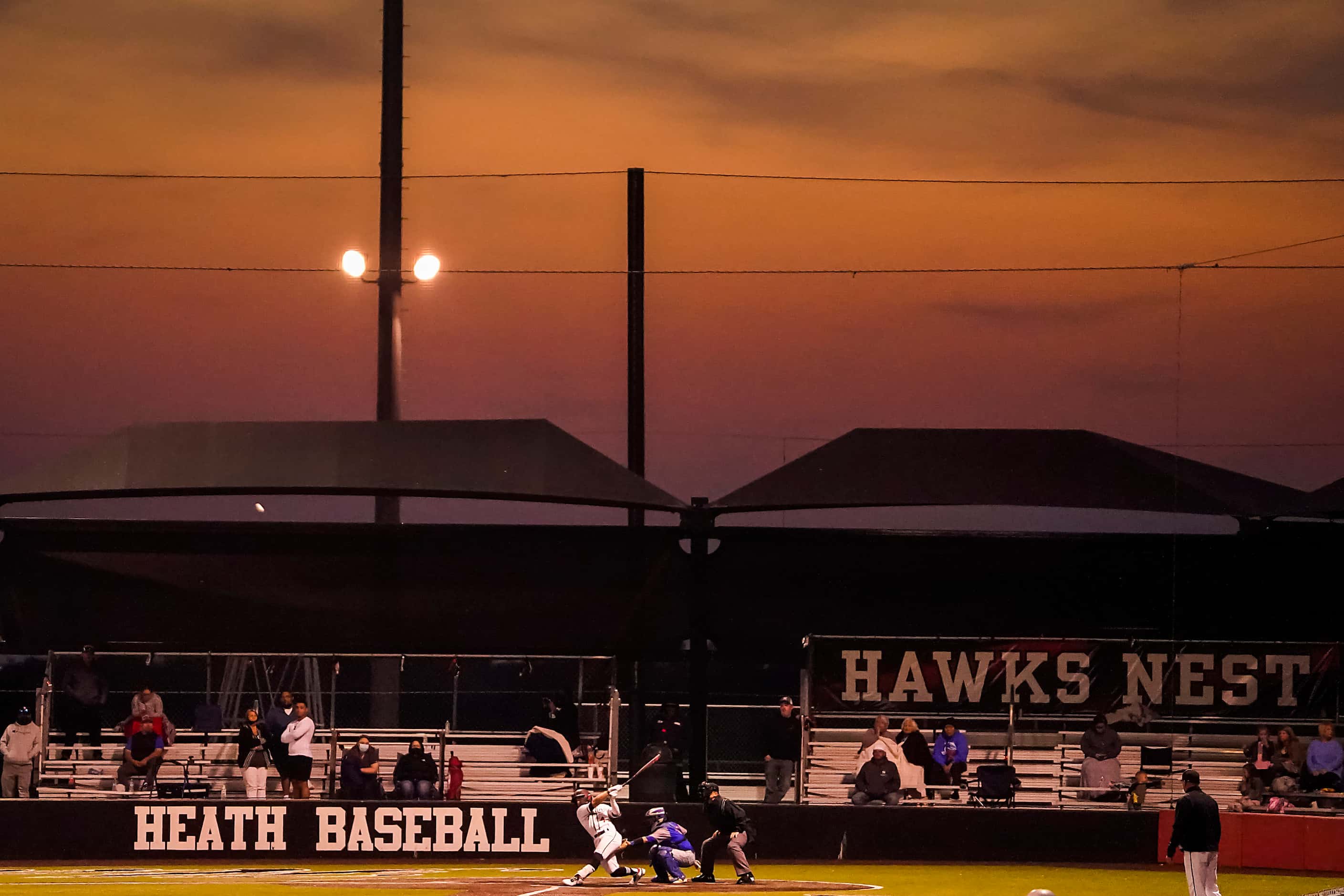 Rockwall-Heath center fielder Jett Williams bats as the sun sets on the Hawks Nest during a...
