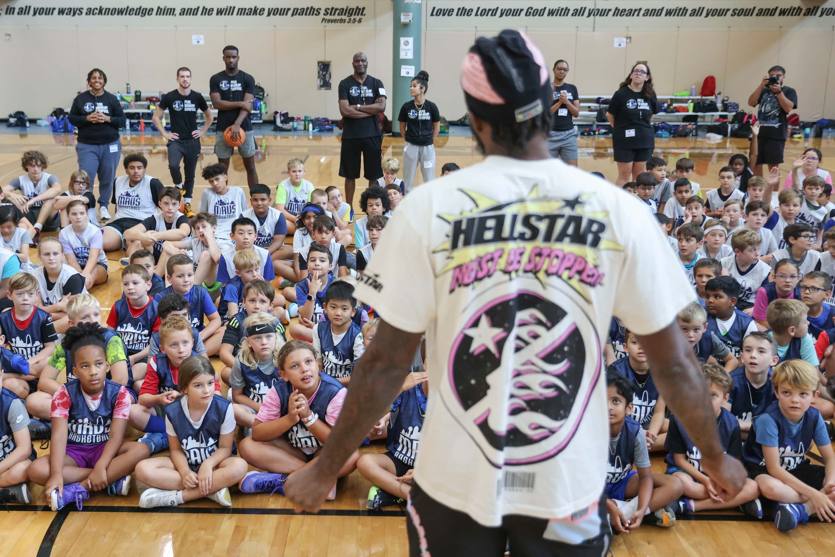 Young basketball campers listen to Dallas Mavericks’ Naji Marshall, during a Hoop Camp,...