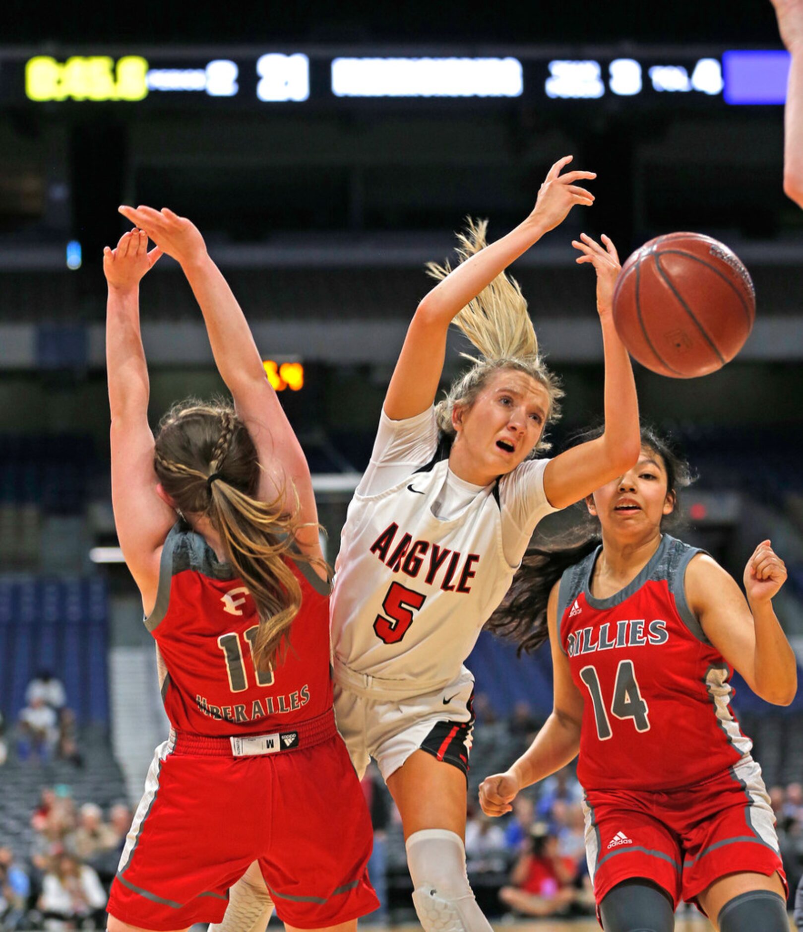 Argyle guard Rhyle McKinney #5 drives to the basket as Fredericksburg guard Brittley Bowers...