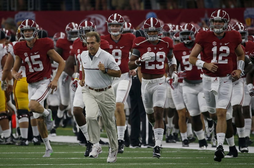 Alabama head coach Nick Saban leads his team onto the field prior to the Alabama and USC...