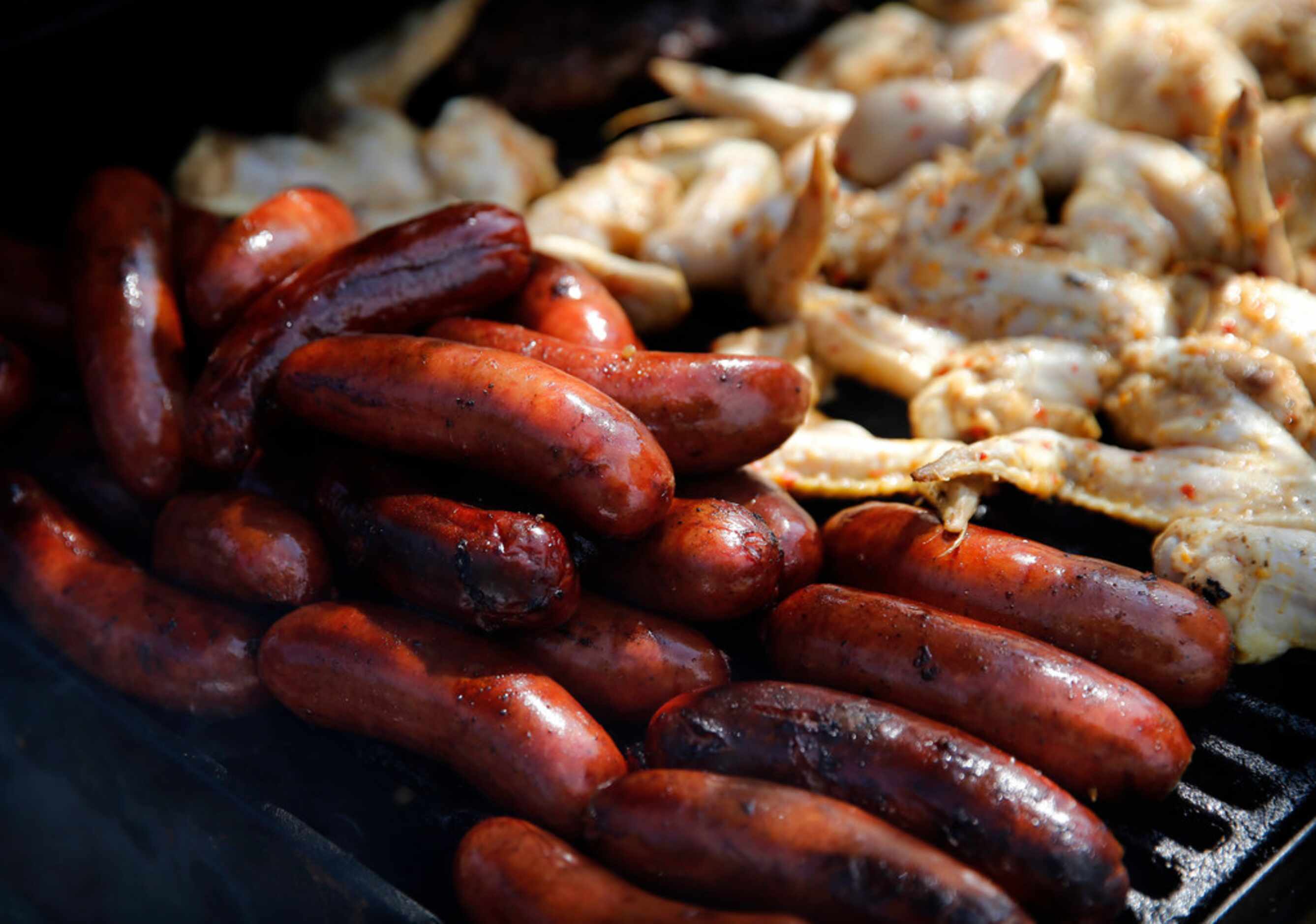 Dallas Cowboys fan Frank 'Peewee' Orange  grilled sausage links and chicken during a...