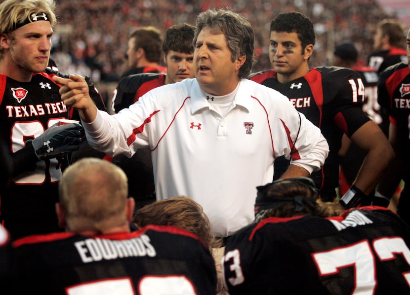 FILE - Texas Tech head coach Mike Leach talks with his team in the second quarter of an NCAA...