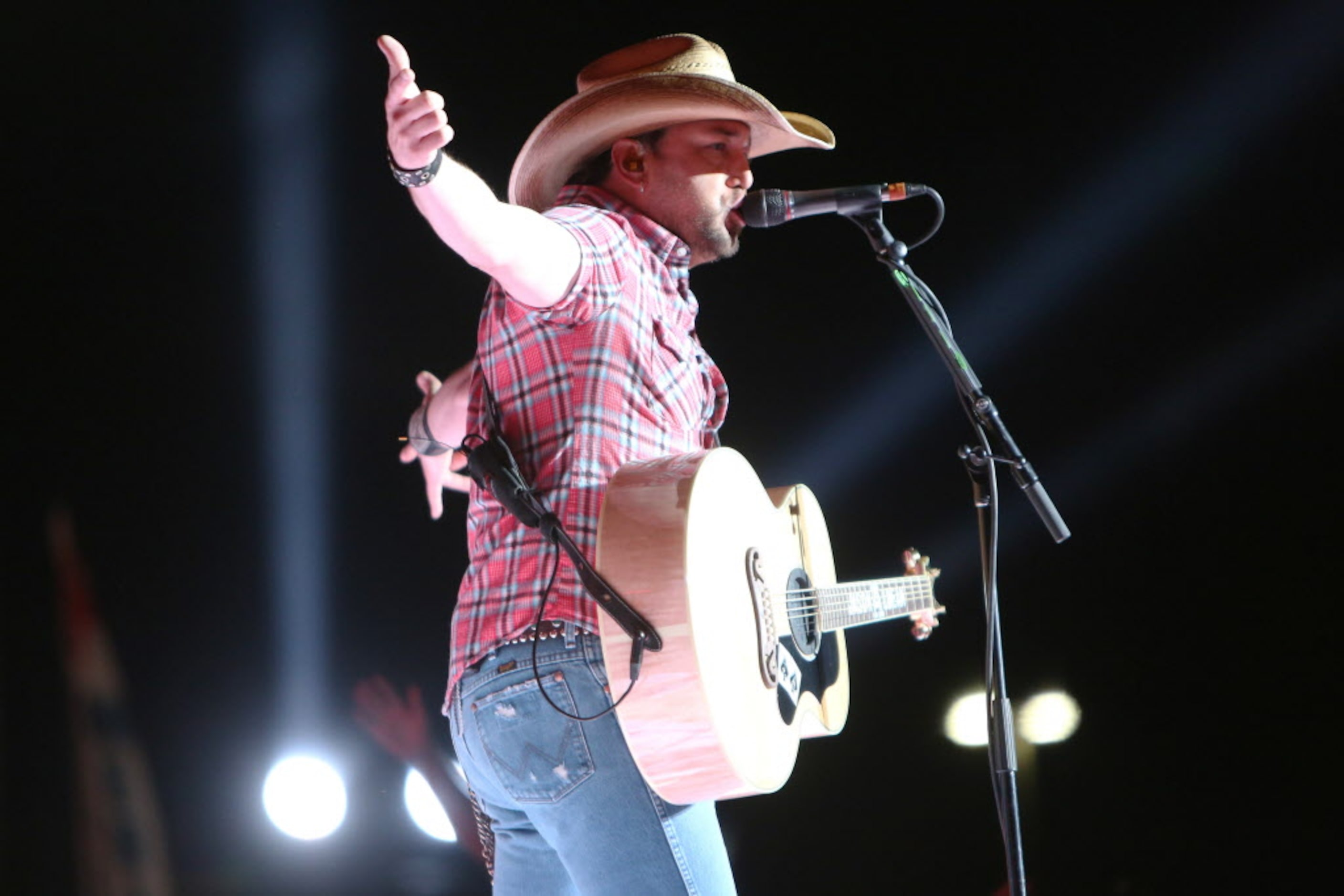 Jason Aldean performs onstage at the 2014 NCAA March Madness Music Festival during the NCAA...