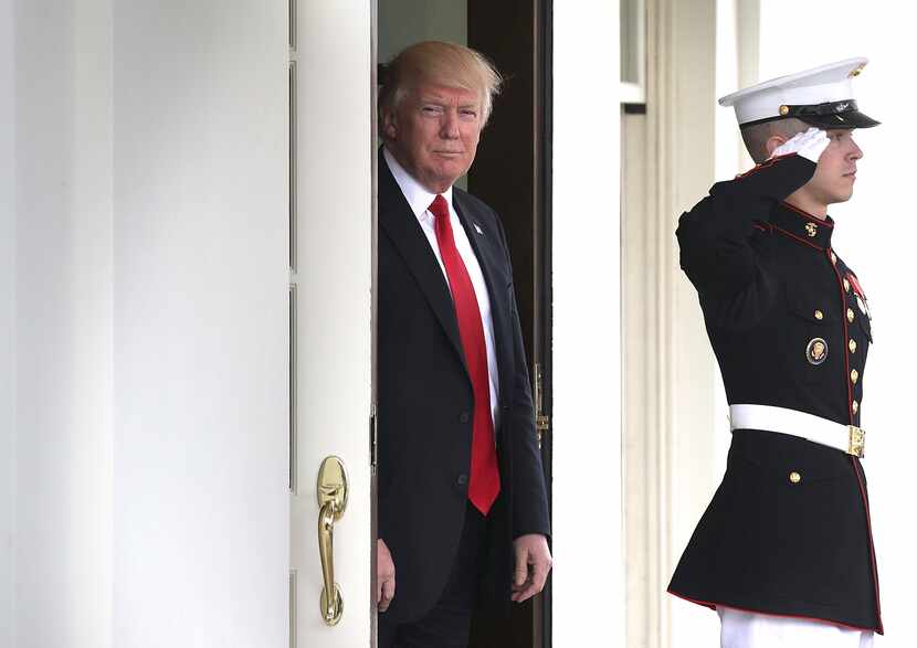 President Donald Trump waits to greet Prime Minister Lokke Rasmussen of Denmark outside the...