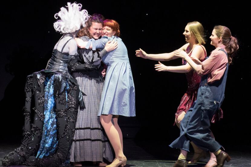 Mansfield High School's Shelby Priddy, second from left, is  hugged by her fellow award...