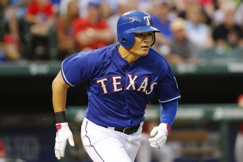 Texas Rangers right fielder Shin-Soo Choo (17) runs to first after grounding out forcing a...