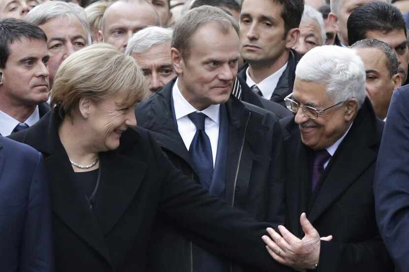 
German Chancellor Angela Merkel stood with Palestinian President Mahmoud Abbas (right) and...