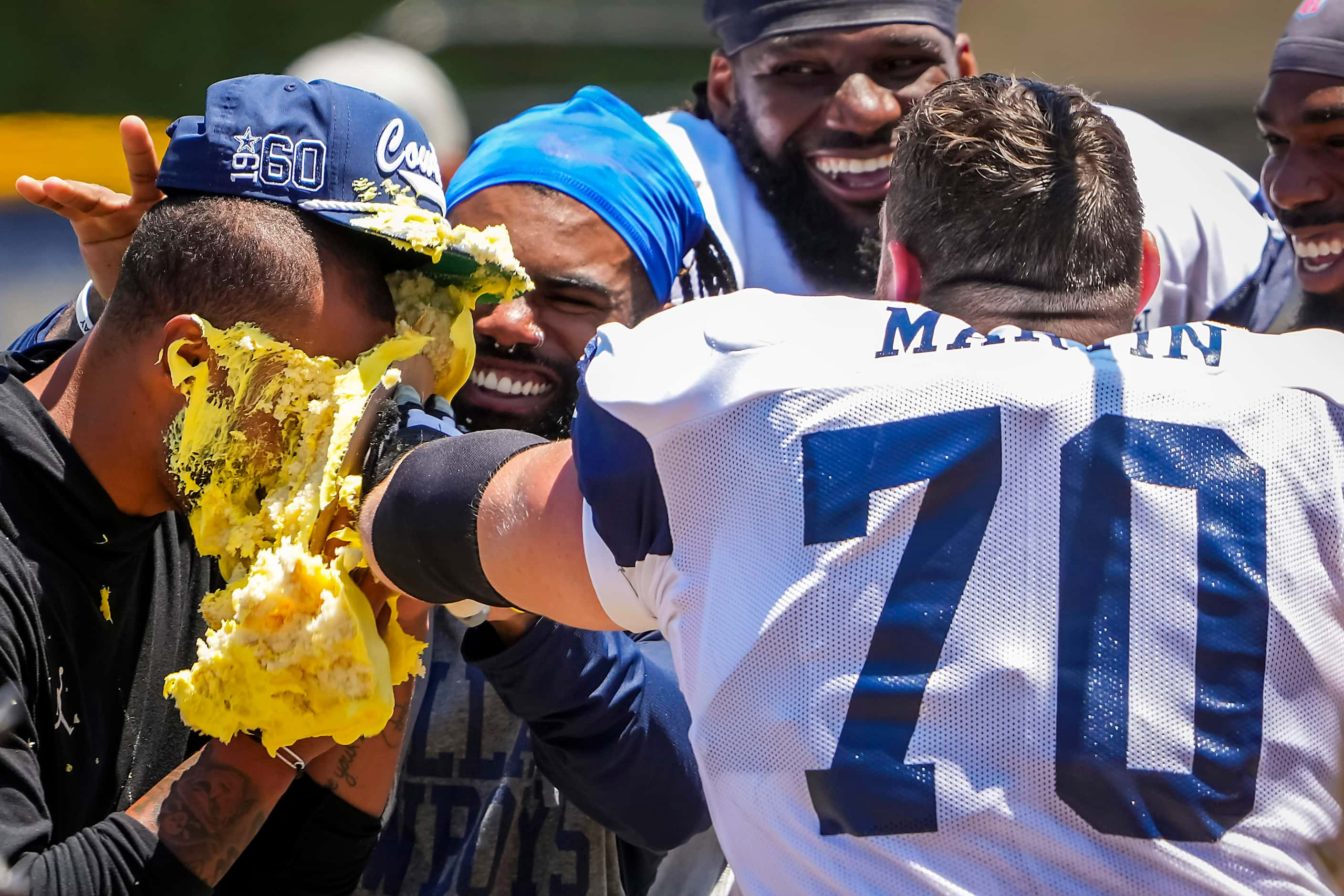 Dallas Cowboys quarterback Dak Prescott gets a cake to the face from his teammates,...