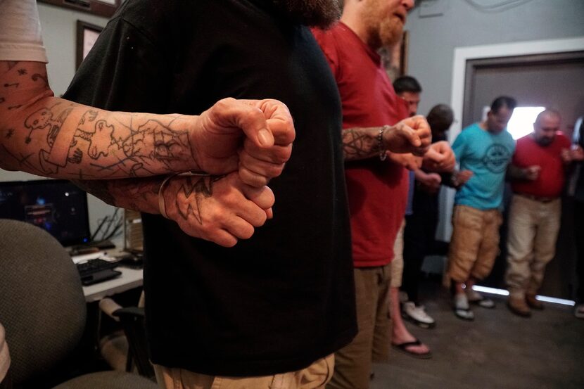 Residents pray after a meeting at Soul’s Harbor in Dallas.