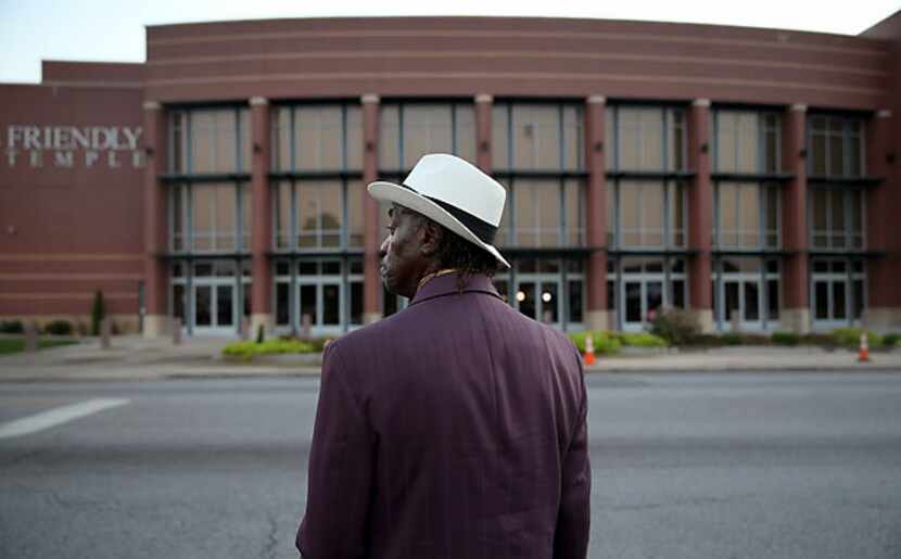 James Wright waits for the Friendly Temple Missionary Baptist Church to open for the funeral...