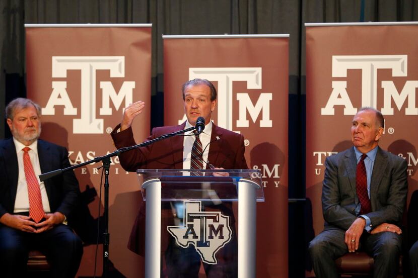 Texas A&M's new coach Jimbo Fisher next to A&M president Michael K. Young (right) during a...