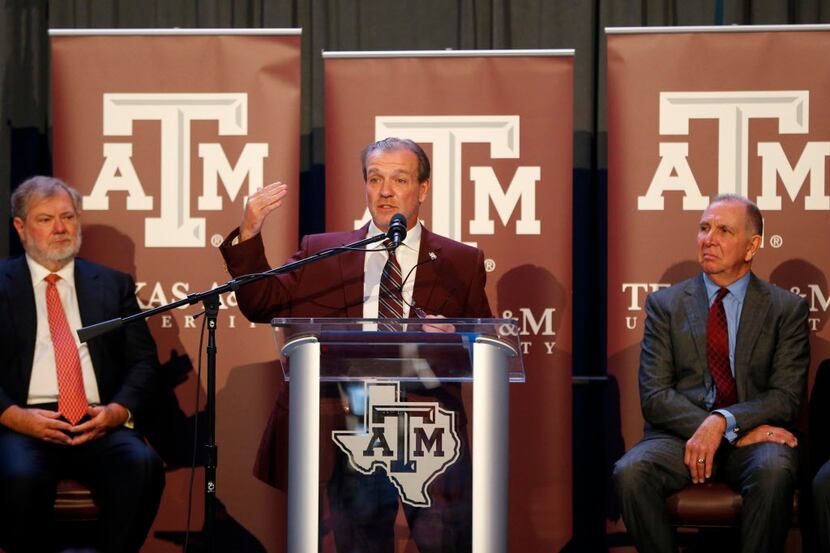 Texas A&M's new coach Jimbo Fisher next to A&M president Michael K. Young (right) during a...