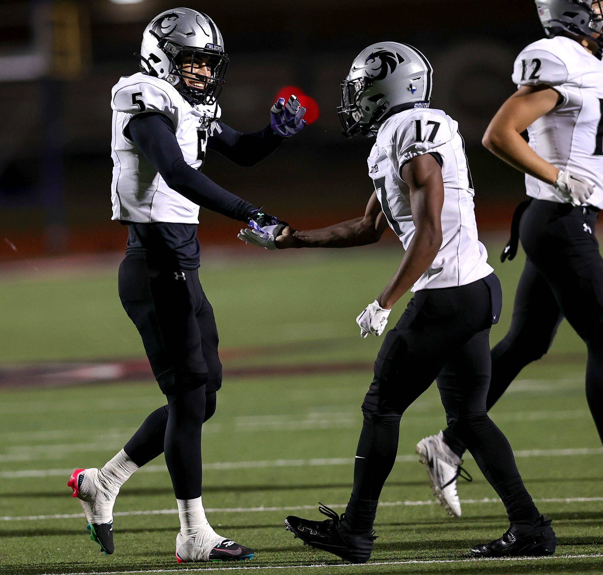 Denton Guyer defensive back Alexis Alvarez (5) celebrates with defensive back DJ Reese (17)...