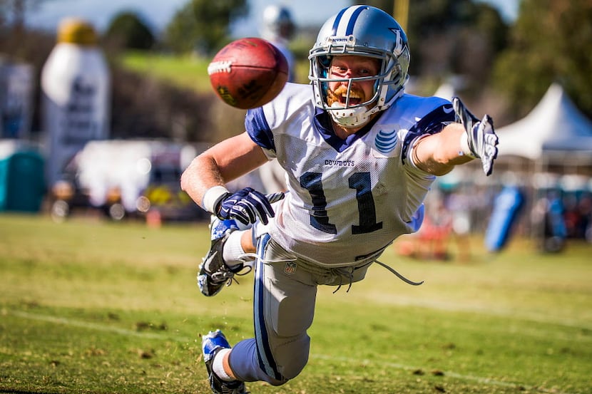 Dallas Cowboys wide receiver Cole Beasley dives for a pass during afternoon practice at...