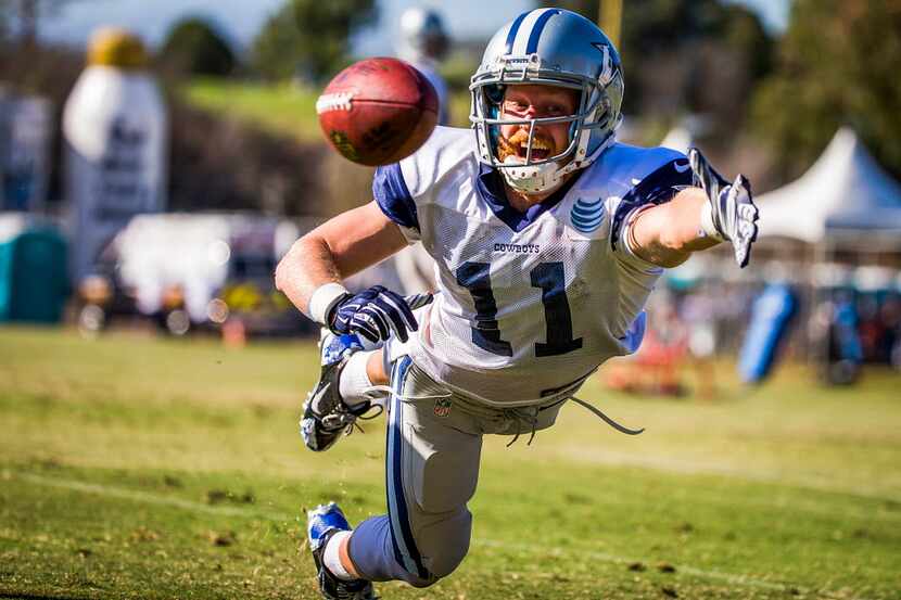 Dallas Cowboys wide receiver Cole Beasley dives for a pass during afternoon practice at...