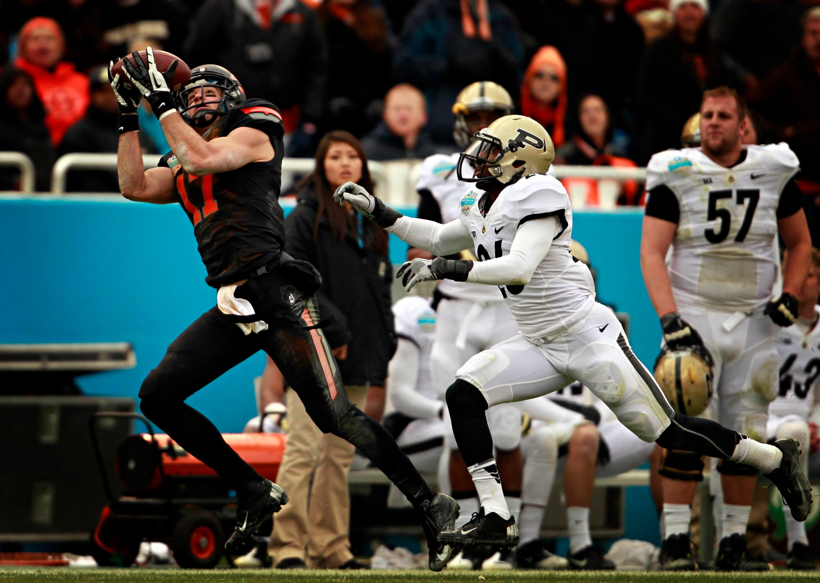 Oklahoma State Cowboys wide receiver Charlie Moore (17) catches a pass ahead of Purdue...