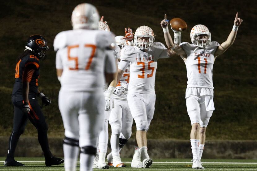 (TXHSFB) Celina High's Shane Gerths (35) holds the football high, as he celebrates with...