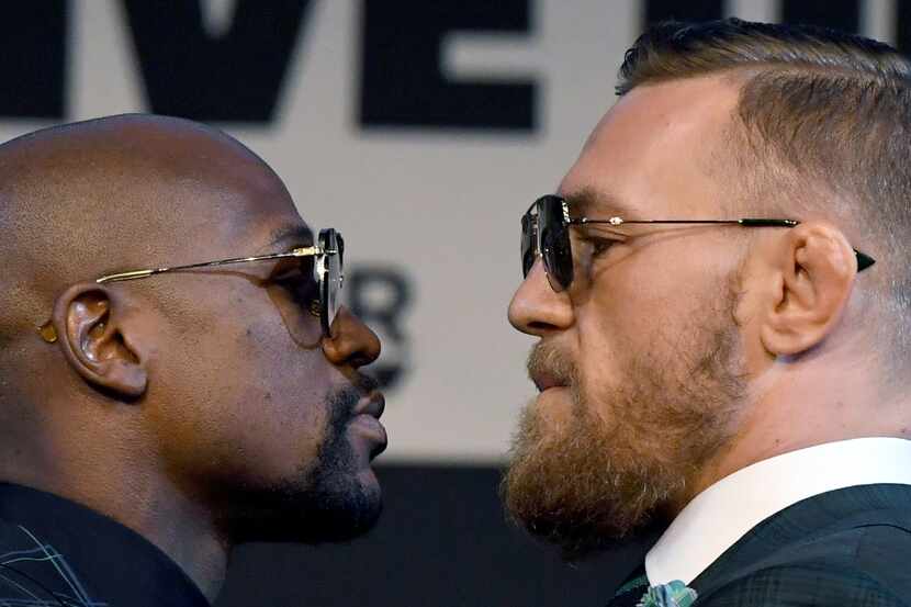  Boxer Floyd Mayweather Jr. (left) and UFC lightweight champion Conor McGregor face off...