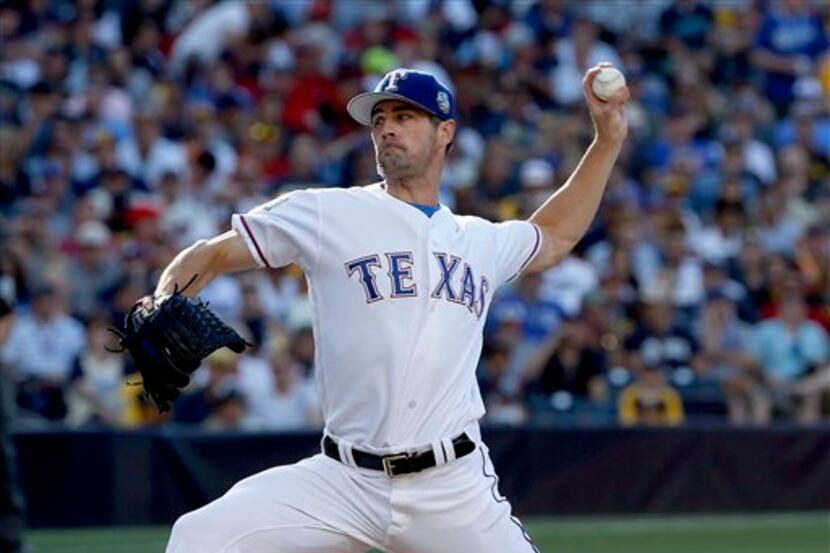 American League's Cole Hamels, of the Texas Rangers, throws against the National League...