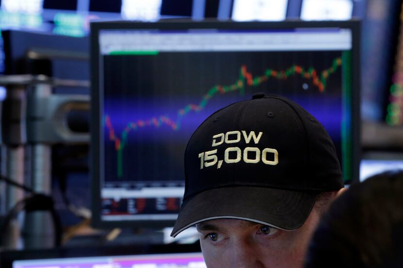 A specialist wore a "Dow 15,000" hat as he worked at his post on the floor of the New York...