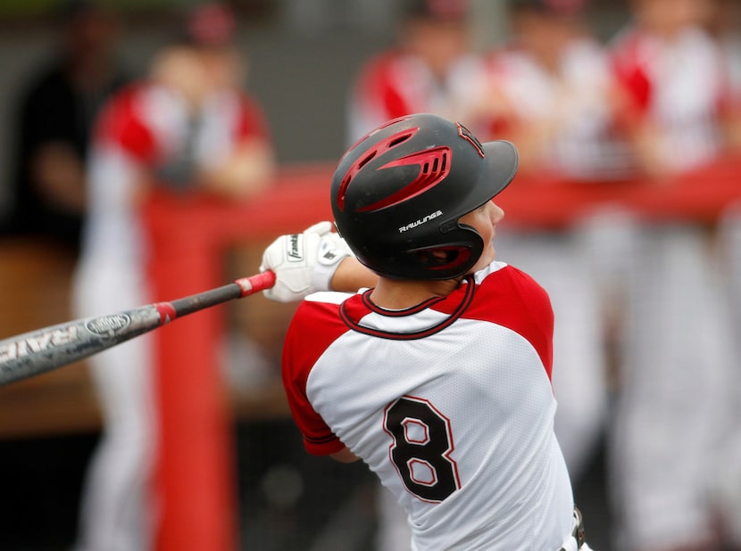 Rockwall Heath catcher Kevin Bazzell (8) watches his RBI double power its way to the...