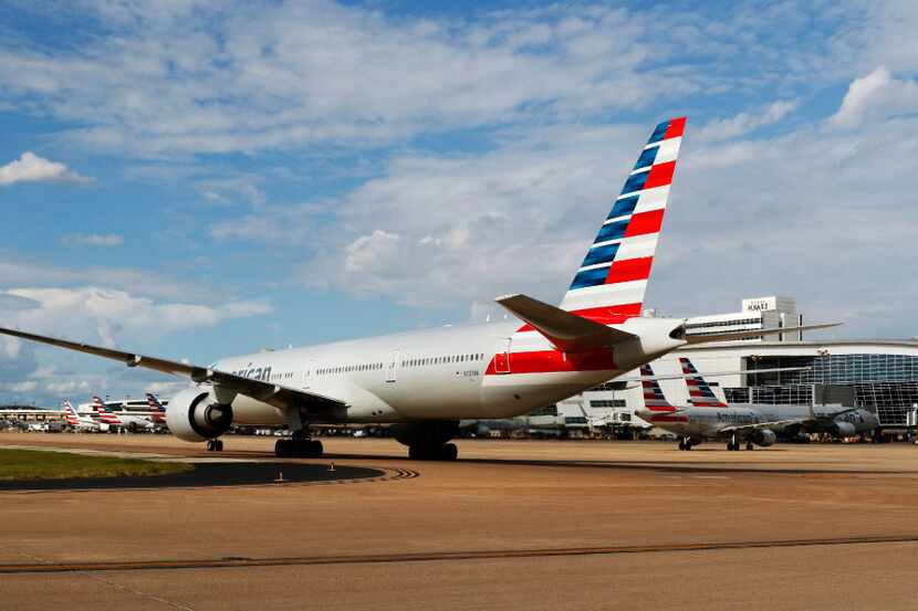 An American Airlines plane taxis at DFW International Airport.
