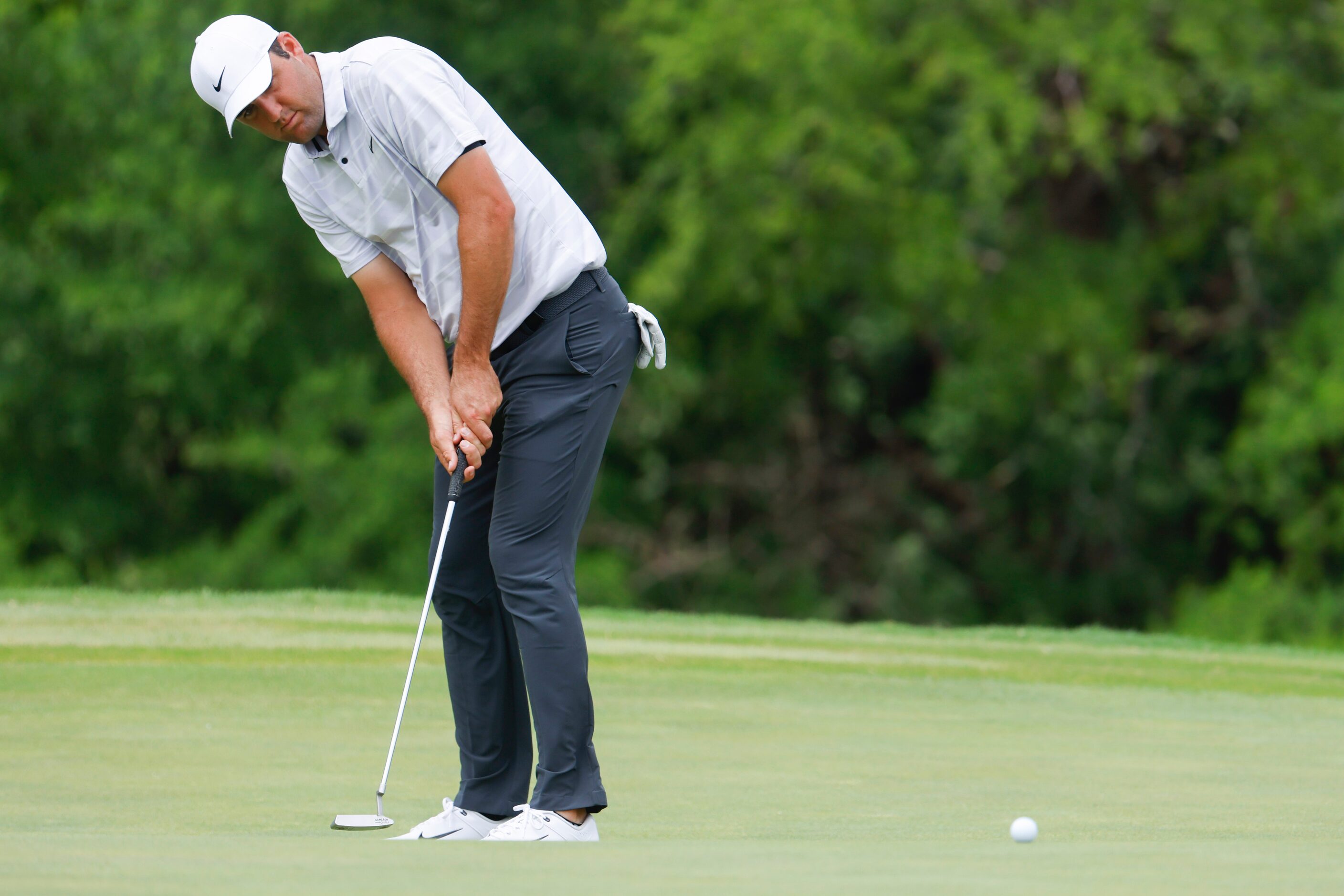 Scottie Scheffler of United States putts on the ninth hole during the second round of the...