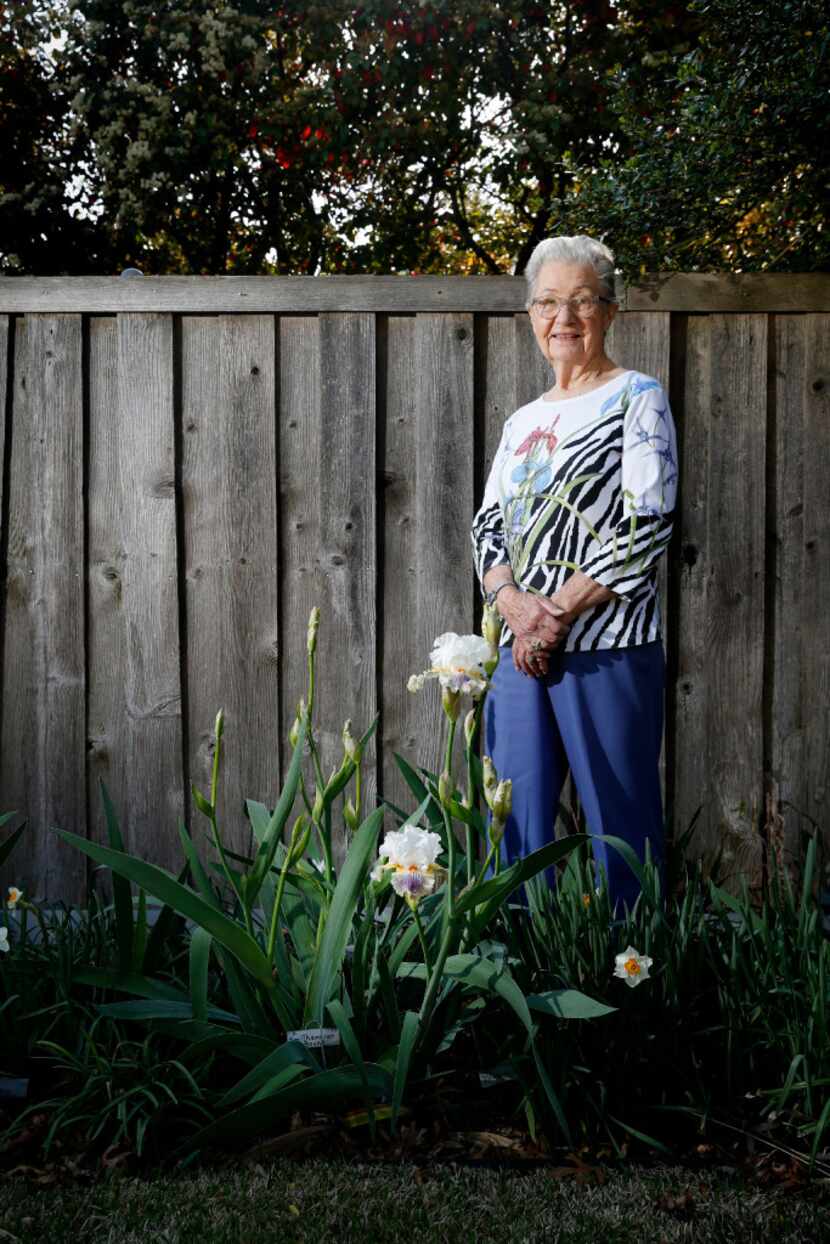 Pat Norvell has an iris nursery in her backyard.  Norvell, 86, poses with 'Smithsonian...