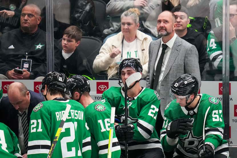 Dallas Stars head coach Pete DeBoer looks up from the bench during a timeout in the third...