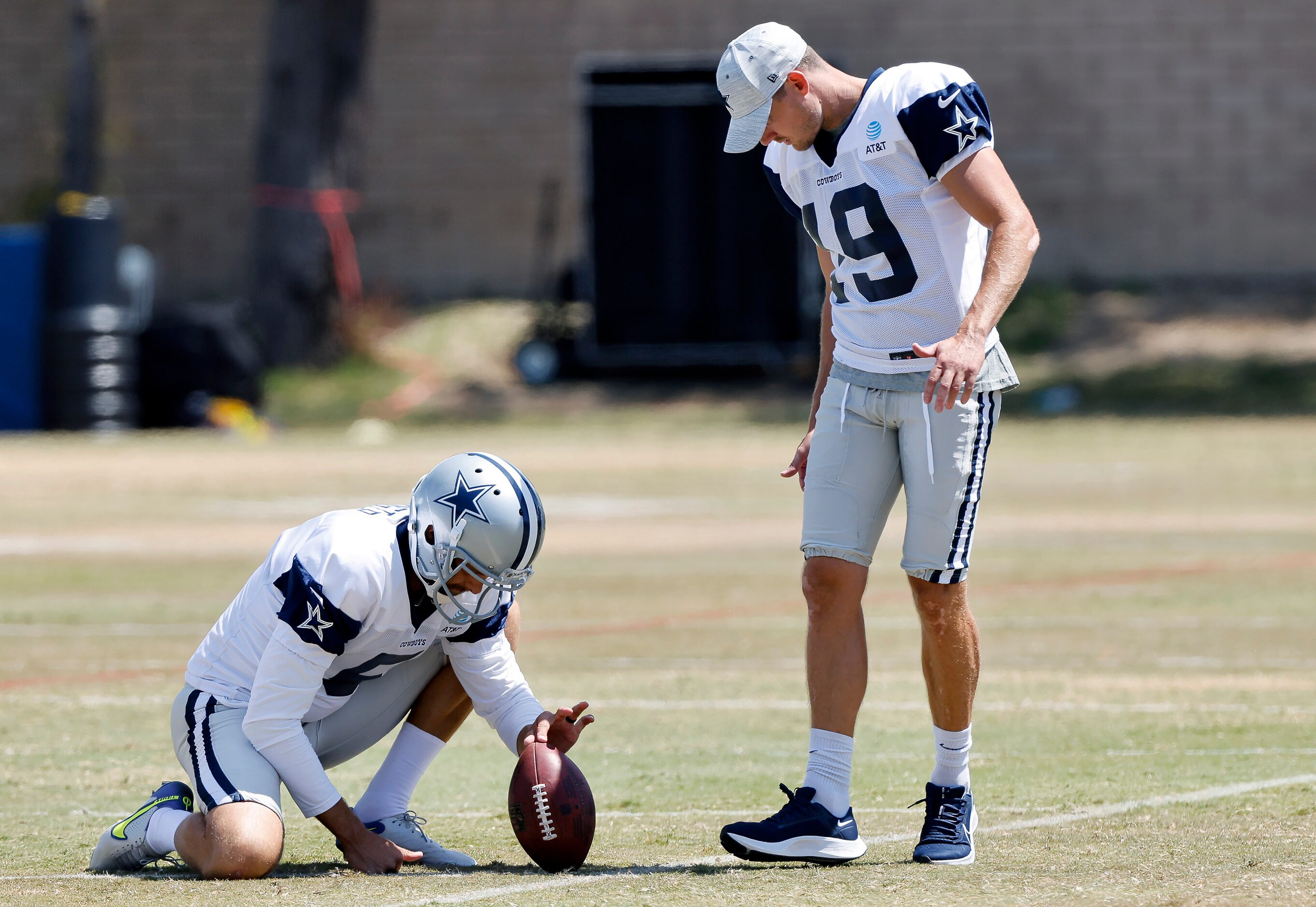 Dallas Cowboys newly singed kicker Brett Maher (19) walks through a long snap during...