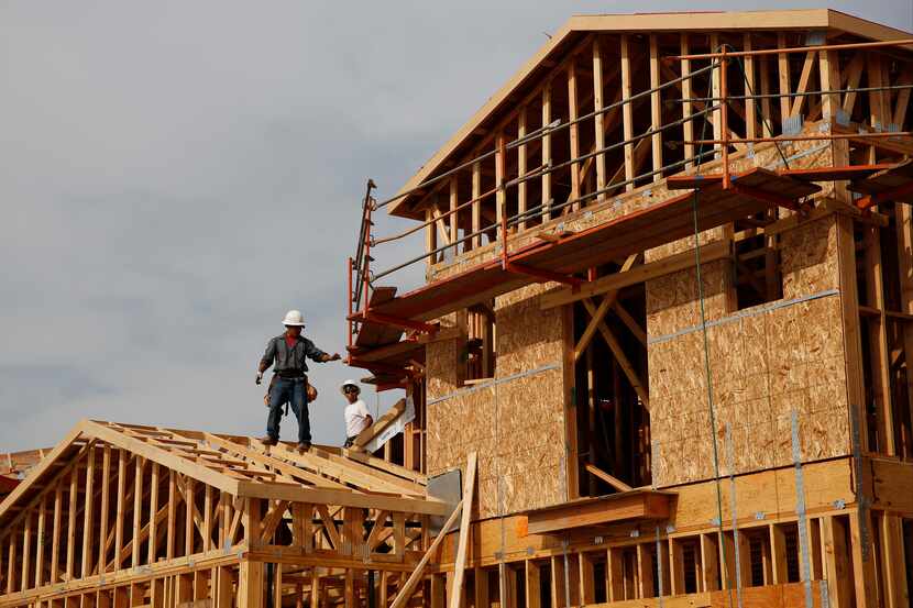 Workers frame new homes at a Toll Brothers Inc. community in California.